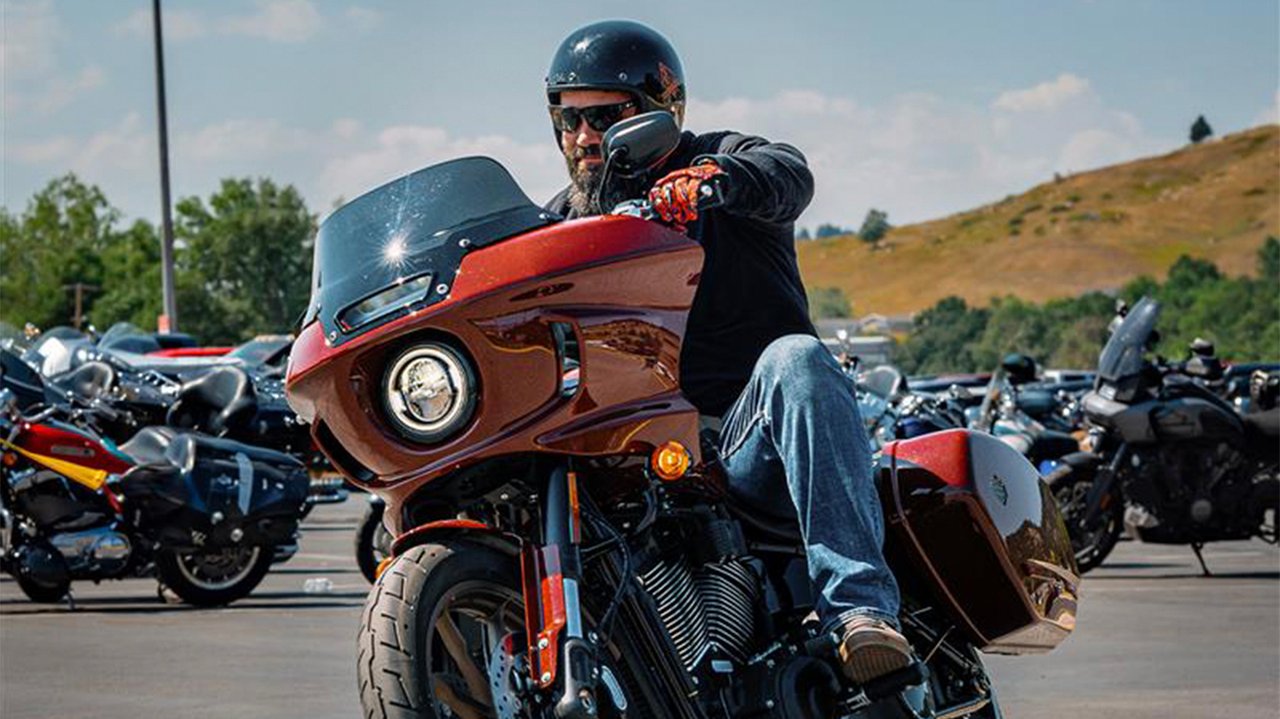man test riding a low rider st